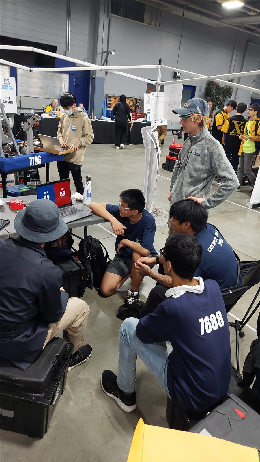 Team 7688 members working in the pits at competition