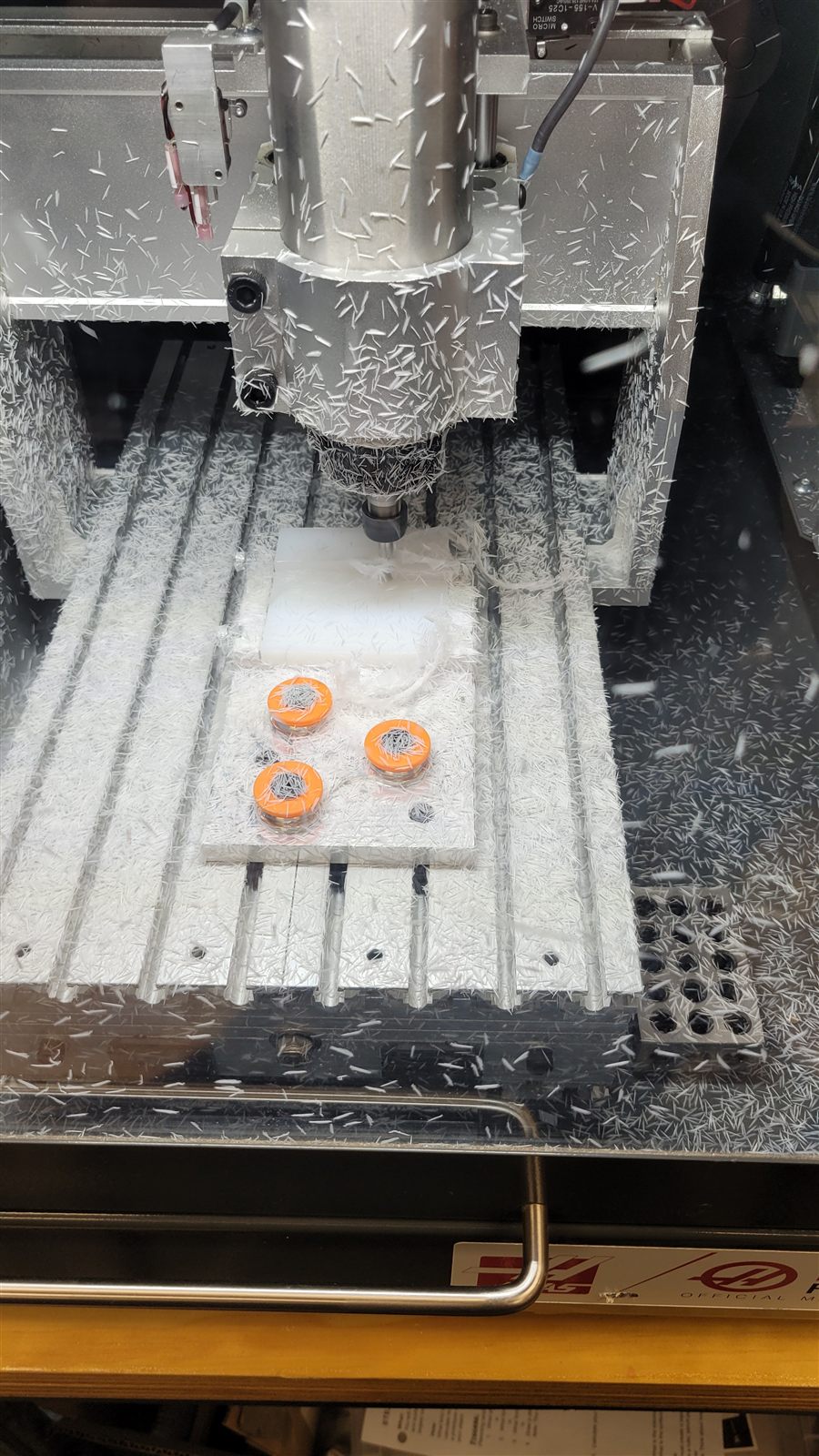 HAAS desktop mill cutting the spinner from a plastic block
