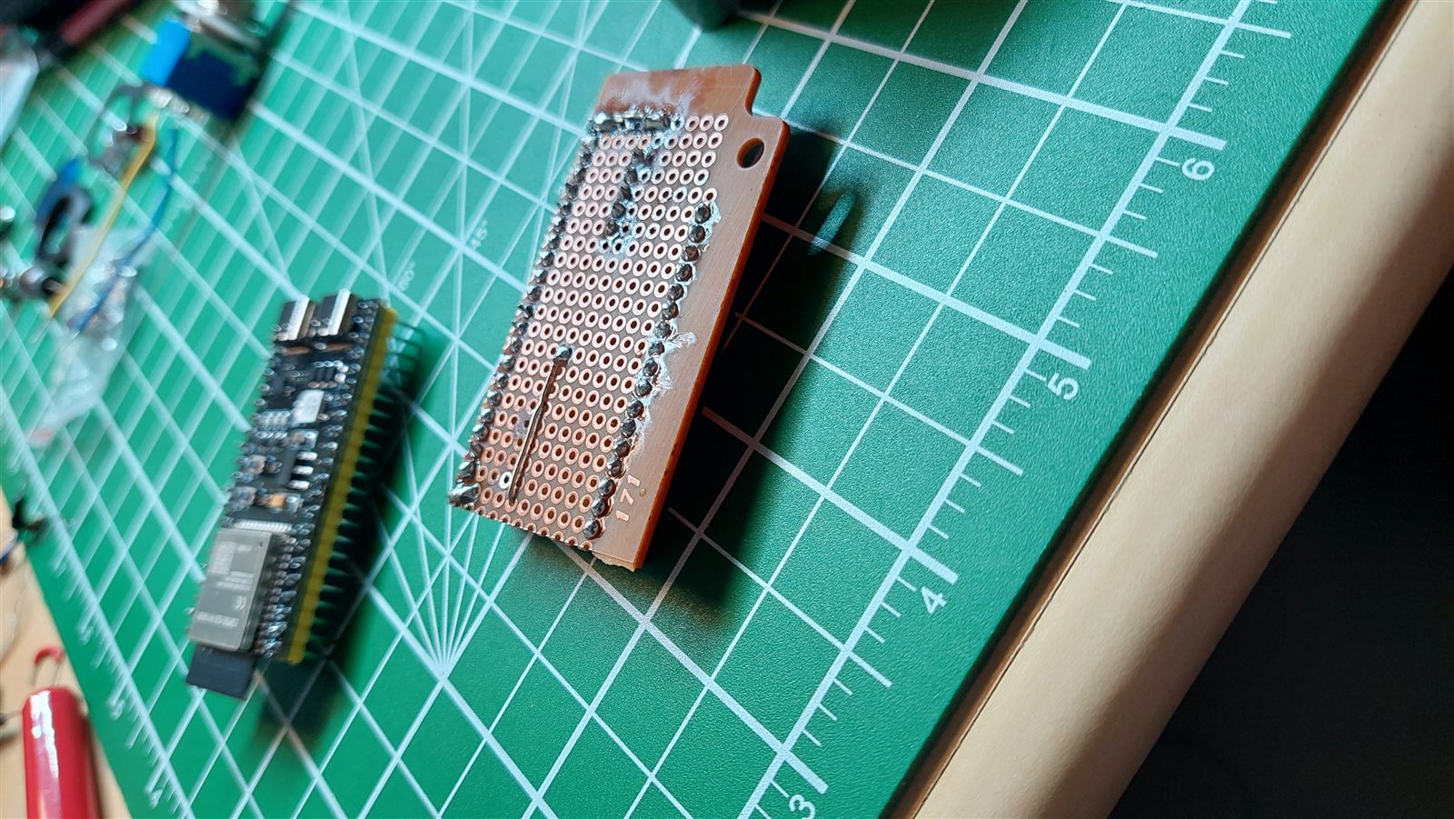 ESP32-S3 board next to a perfboard